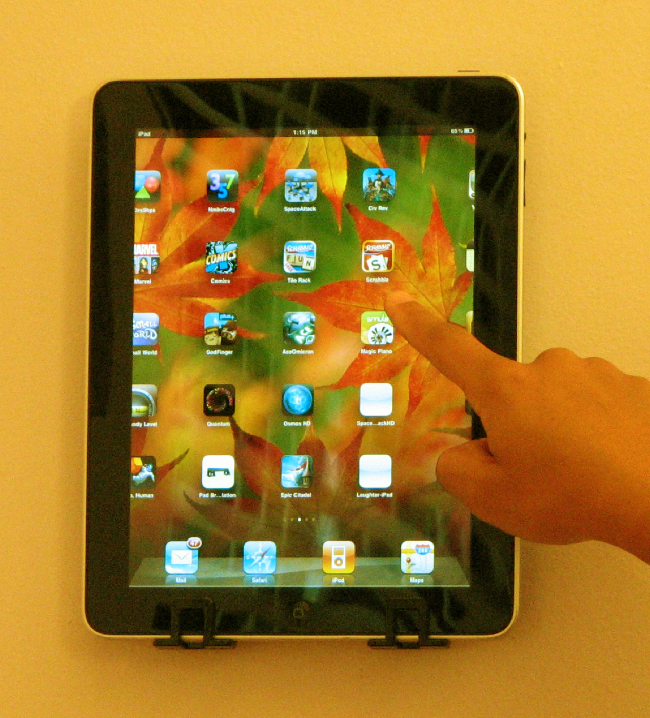 iPad mounted in Pad Bracket with finger touching the screen